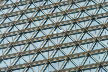 Wall Mural - A beautiful background of an glass office building, reflecting clouds in the opened windows