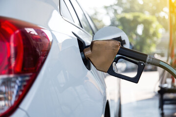 Pumping gasoline fuel in car at gas station.concept Travel,price oil,industrail business and transportation..