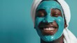 Happy Young Man Enjoying a Turquoise Facial Mask