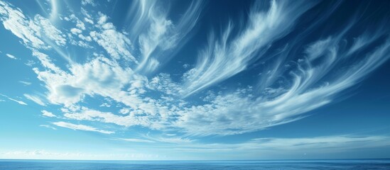 Wall Mural - Peaceful blue sky with fluffy white clouds and soft sunlight in a serene nature landscape scene