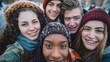 Multiracial selfie with friends walking on a city street, young people having fun and taking photos, young people laughing at the camera, friendship and tourism concept.