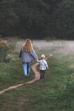 Fototapeta  - mother and child walking in the park