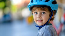 Closeup Of A Beautiful And Cute Little Preschooler Boy Wearing A Blue Bike Helmet, Looking At The Camera And Smiling. Male Kid Or Child Checking Safety Before Driving A Bike Outdoors In The Summer