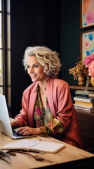 Poster - Stylish smiling Woman of 50 years old, Confident Cheerful interior designer, Creative Director, Graphic designer, Photographer working at a computer in the office.