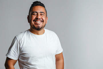 Wall Mural - Confident Man Smiling in White T-Shirt Against Neutral Background: A Portrait of Positivity and Assurance