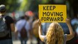Motivational concept  woman holds  keep moving forward  sign, success symbol on blurred background.