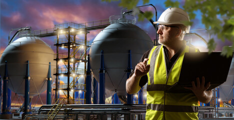 Poster - man industrialist with laptop. guy factory manager. industrialist near modern factory. night manufac