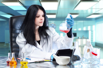 Poster - female microbiologist at work. laboratory assistant sits at table with flasks. scientist engaged in 