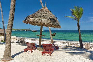 Canvas Print - Chair and green trees on a white sand beach. Watamu, Kenya - Africa.