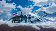 Statue Of Wooden Mountain Goat With Panoramic View Of Snow Covered Mountain Peaks Of High Tauern Along Grossglockner High Alpine Road, Carinthia Salzburg, Austria. Austrian Flag Waving In The Wind