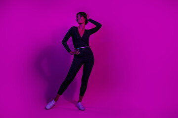 Wall Mural - Full body photo of attractive young woman posing look empty space wear trendy overall clothes isolated on neon light pink color background