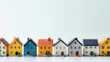 © DJSPIDA FOTO - miniature houses in a row, each painted with distinct, lively colors. Perfectly suited for concepts of diversity, real estate investment, and community housing projects.