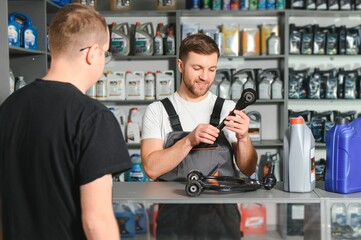 Wall Mural - A customer speaks with a consultant at an auto parts store