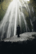 Majestic Waterfall in Iceland with Lone Male Explorer