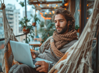 Sticker - Young man using laptop while relaxing in hammock on balcony