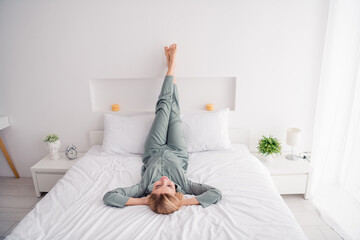 Poster - Full body photo of young girl daydreaming imagine her life in future sleepy take nap lying down legs upside indoors perfect white bedroom