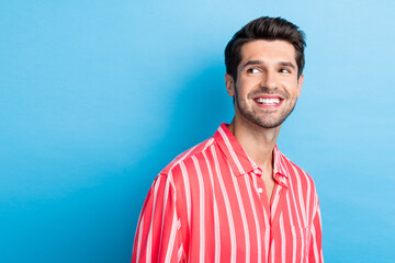 Poster - Photo of optimistic cheerful man with bristle dressed striped shirt look at proposition empty space isolated on blue color background