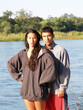 Man And Woman Standing At River In Bright Sunlight