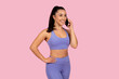 © Prostock-studio - Sporty woman talking on phone in workout attire