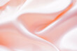 © Chaisi - Light pink silk or satin wavy background beautiful and luxurious Space for design. Close-up. Blurred or blurry.