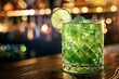 St Patrick's Day green cocktail on a bar with a lime wheel garnish