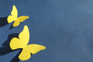 Poster - Yellow paper butterflies on dark blue background, top view. Space for text