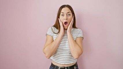 Sticker - Astonished young woman with blue eyes, scared and awestruck, standing open-mouthed in disbelief over isolated pink background.