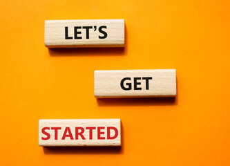 Wall Mural - lets get started symbol. concept words lets get started on wooden blocks. beautiful orange backgroun