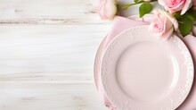 Light Pastel Colored Tableware Set: Plate, Vintage Silverware On Napkin And Delicate Pink Roses On Rustic Shabby Wooden Background With Copy Space. Top View