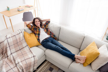 Sticker - Top view angle photo of dreamy funky guy wear plaid shirt lying sofa arms behind head indoors room home house