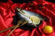 Two herrings with lemon slices on a red background, top view