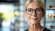 © evgenia_lo - Middle-aged woman trying on new eyeglasses, recommended by experts, at optical shop. eyesight and vision concept - portrait of smiling mature woman trying new glasses at optician store