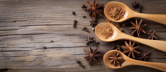 Wall Mural - Three wooden spoons crafted from hardwood filled with aromatic spices resting on a wooden table made from natural materials.