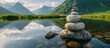Tranquil scene of rock stack peacefully perched on top of serene lake
