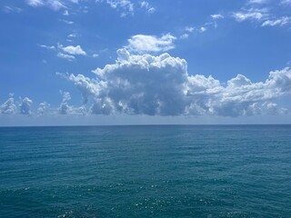 Blue sea shining water and beautiful clouds in the sky 