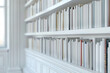 Serene Library Nook: A Banner Display of White Bound Literature on Shelves Awaits Readers