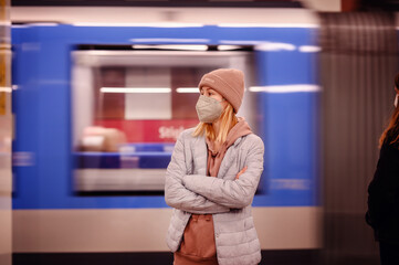 Wall Mural - Woman Observing Fast-Moving Train at Subway Station