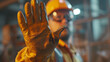© MP Studio - close-up of a worker in safety gear extending a gloved hand in a stop gesture.
