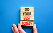 Do your best today symbol. Concept words Do your best today on beautiful wooden block. Beautiful blue table background. Businessman hand. Business motivational do your best today concept. Copy space