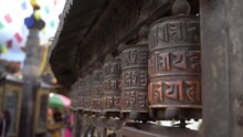 Spinning Religious Prayer Wheels With Written Mantra Om Mani Padme Hum. Kathmandu, Nepal.