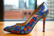 An elegant high-heeled shoe with an interesting variegated design in an urban business environment