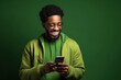 © AI_images - Happy African American Man with phone on Forest Green studio background