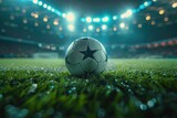 Fototapeta Sport - A close-up of a wet soccer ball on the grass field under the stadium lights at night, capturing the ambiance of an evening game.