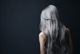 Fototapeta  - Rear view of a girl with flowing long gray hair, care and hair care concept