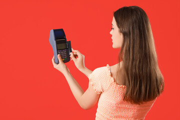 Sticker - Young woman paying with credit card via terminal on red background, back view