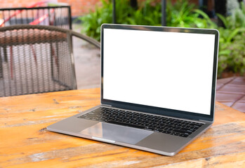 Wall Mural - Laptop with blank screen on a table in the cafe.
