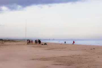 People on a wild beach in a winter day