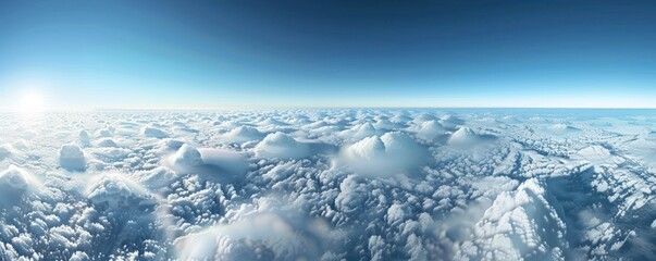 Wall Mural - a stunning aerial panorama of dense cumulus clouds bathed in sunlight, with a clear blue sky above.