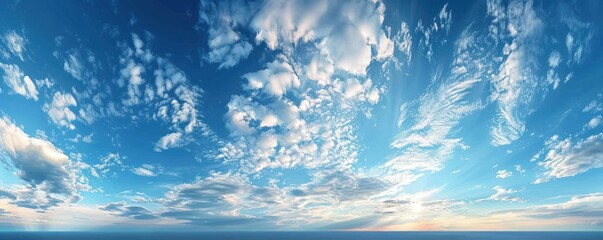 Wall Mural - a stunning aerial panorama of dense cumulus clouds bathed in sunlight, with a clear blue sky above.