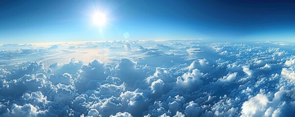 Wall Mural - a stunning aerial panorama of dense cumulus clouds bathed in sunlight, with a clear blue sky above.